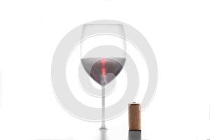 Wine cork stopper and silhouette of red wine glass isolated on white background with copy space for your text