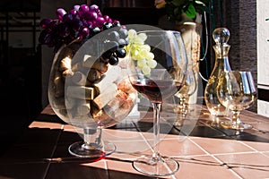 Wine corks, bunch of grapes and glass of red wine