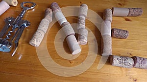 Wine corks and corkscrew arranged in the shape of word `Wine`