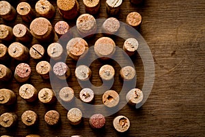 Wine corks of different sizes, standing upright on an old wooden surface. Background for liquor