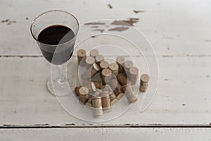 Wine corks and glass of wine
