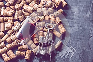 Wine corks grape shape and vine on stone table.