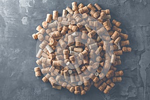 Wine corks grape shape and vine on stone table.