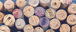 Wine corks grape shape and vine on stone table.