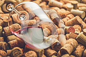 Wine corks grape shape and vine on stone table.