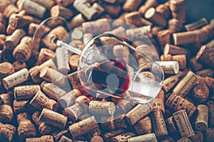 Wine corks grape shape and vine on stone table. Top view with copy space for your text.