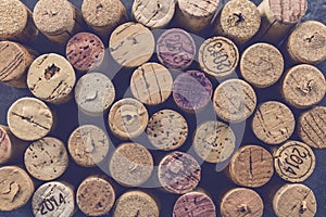 Wine corks grape shape and vine on stone table. Top view with copy space for your text.