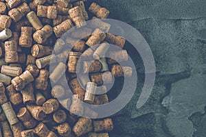 Wine corks grape shape and vine on stone table. Top view with copy space for your text.