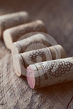 Wine corks on old wooden background, selective focus point