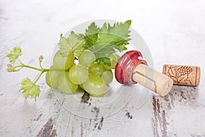 Wine corks, white grapes and wine leaves.