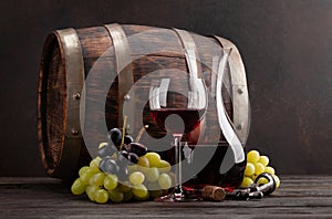 Wine decanter, glass and old wooden barrel