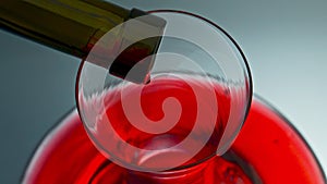 Wine drops falling glass decanter closeup. Blob splashing from bottle neck