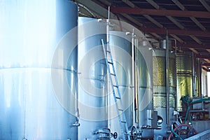 Wine Fermenting in huge vats in a famous wine cellar. Ground level