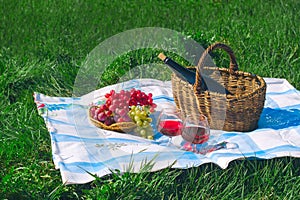 wine and fruit basket , picnic and summer vacation concept