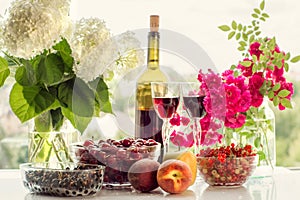 Wine, fruit, berries and flowers.