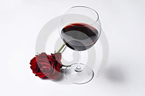 Wine glass and beautiful red rose isolated on white background.Copy space