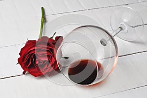 Wine glass and beautiful red rose isolated on white background. petals rose.Copy space