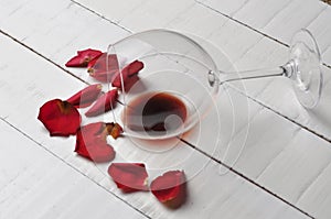 Wine glass and beautiful red rose isolated on white background. petals rose.Copy space