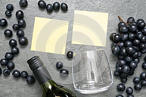 Wine glass, bottle and black grapes