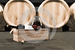 Wine glass and bottle on wine cellar floor