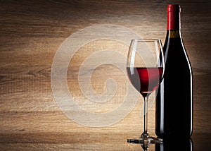 Wine glass and Bottle on a wooden background