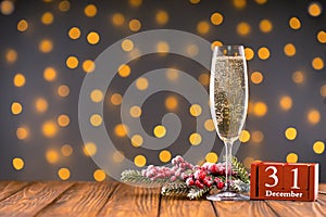 Wine glass with bubbly Champagne on blurry sparkling lights background