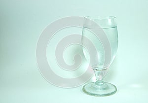 Wine glass and champagne cork on white background.