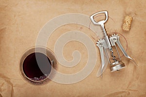 Wine glass, cork and corkscrew with red wine stains