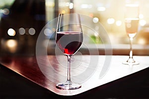 Wine glass in entertaining room among sunset window