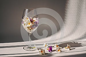 Wine glass filled with flowers.