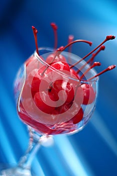 Wine glass holding maraschino cherries