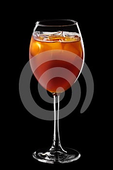 Wine glass with mixed beer, tonic and coffee cocktail isolated on black