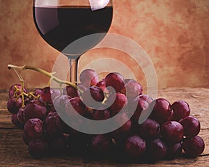 Wine glass and red grapes