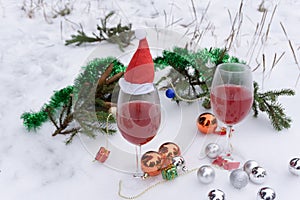 Wine glass with red sparkling wine on a table on a blurred background of christmas lights