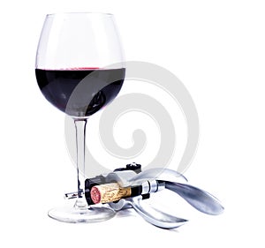 Wine glass with red wine and bottlescrew
