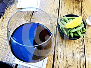 Wine in glass selective focus motion blur Red wine in a glass. Wine with peas and lemon.