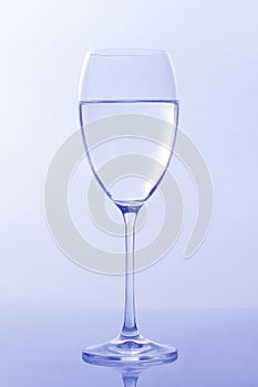 Wine glass of water on light background. tableware for drinks