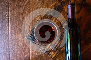 .Wine glass and wine bottle on the wooden table