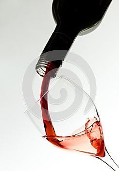 Wine glass and wine puring from bottle as Valentin