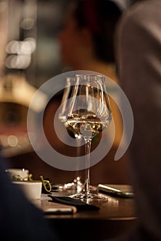 Wine glasses and bottles of wine in the entourage of the wine bar in the evening