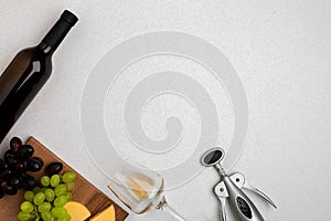 Wine, glasses and corkscrew over white background. Top view
