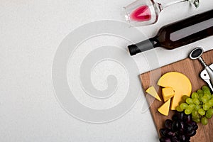 Wine, glasses and corkscrew over white background. Top view