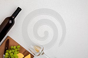 Wine, glasses and corkscrew over white background. Top view