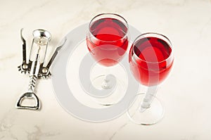 Wine glasses and corkscrew on white marble background/Wine glass