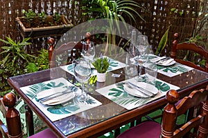 Wine glasses and dishes set on a dinner table