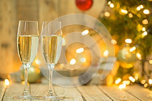 Wine glasses in front of a Christmas tree