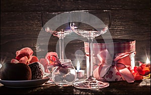 Wine glasses, gift and sweets for a romantic evening