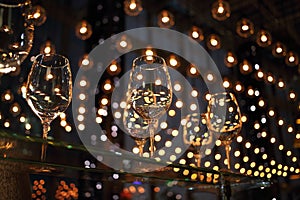 Wine glasses on a glass table illuminated lots of