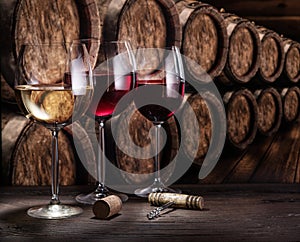 Wine glasses on the old wooden table. Winetasting at the wine cellar