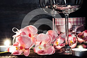 Wine glasses orchids and candles for a romantic evening